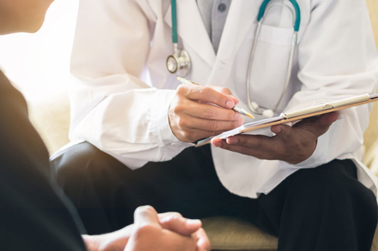 Doctor writing on his notepad