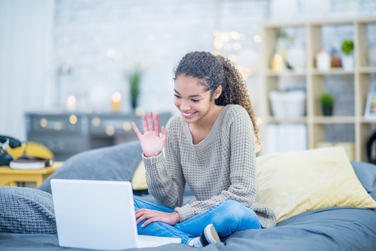 teen having virtual visit on laptop