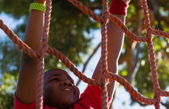 child climbing rope ladder