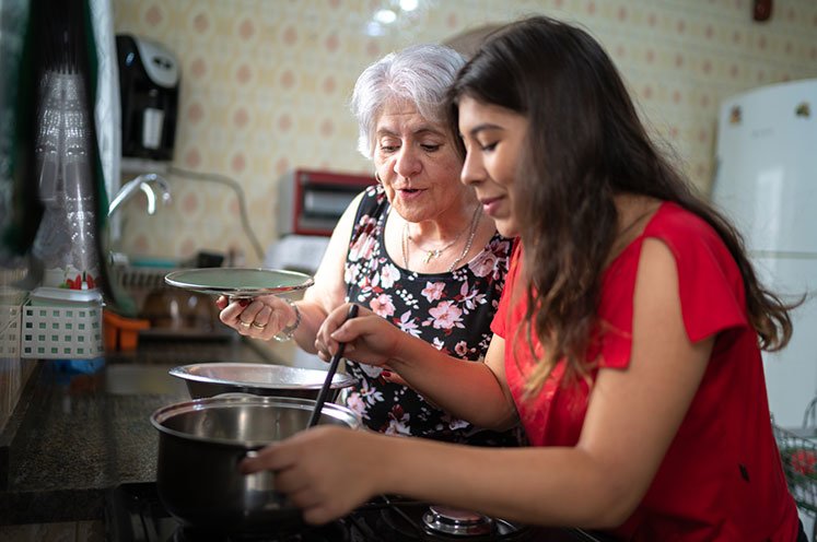 mother and daughter cooking together