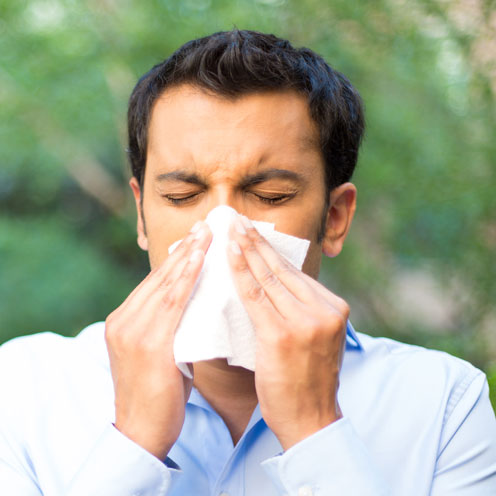 man blowing his nose