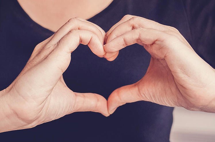 Woman making a heart shape with her hands
