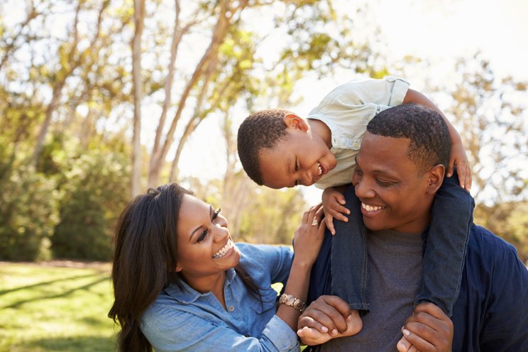 parents with child playing outside