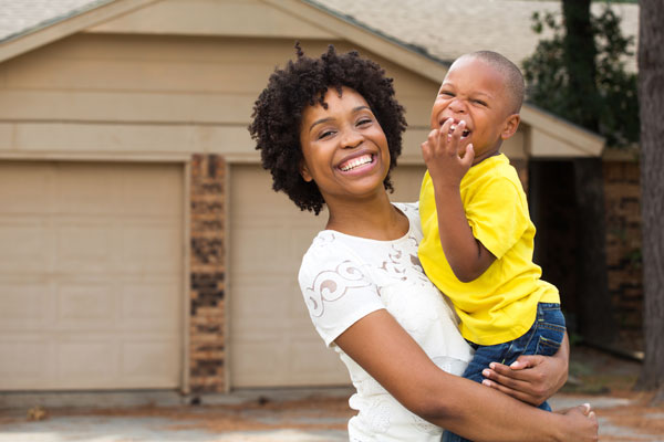Africian American mother and son in the front yard