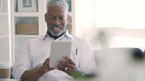 man conducting video visit on tablet