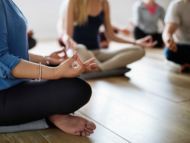 group of people in a seated yoga pose
