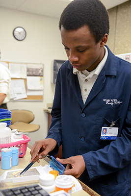 Early college student working in the pharmacy