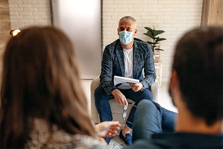 Man with mask on in group setting