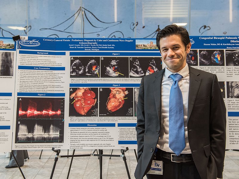 fellow with his poster at the annual Henry Ford Research Forum