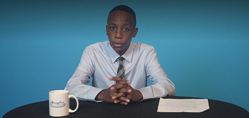 young boy sitting at a table