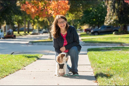 Paula walks her dog on a sunny autumn day.