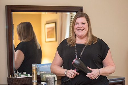 breast cancer patient laura styling her hair during cool cap treatment for chemotherapy