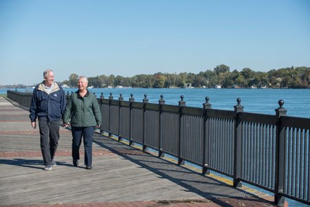 breast cancer patient sharon and husband walking by the water
