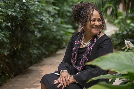 breast cancer patient glenda curry posed in front of garden