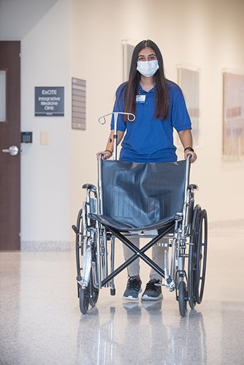 Volunteer pushing wheel chair