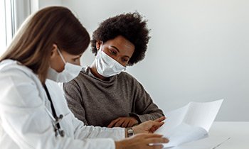 doctor and patient looking at documents