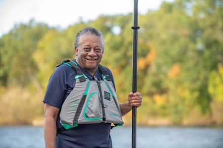 prostate cancer patient donnell holding kayak paddle
