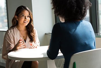 women talking face to face