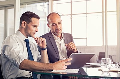 Two men looking at tablet