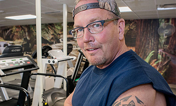 cardiology patient carl miller working out at the gym