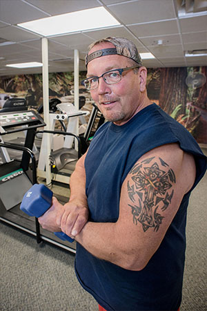 cardiology patient carl miller working out at the gym