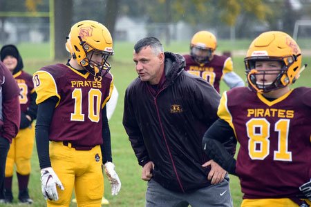 cardiology patient coach chuck singleton with football team