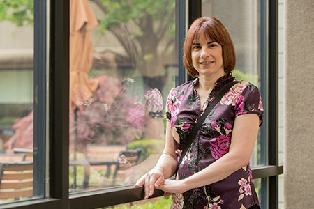 Heart patient Michelle Rachuk standing in front of window