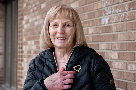 Woman smiling with heart shaped jewelry