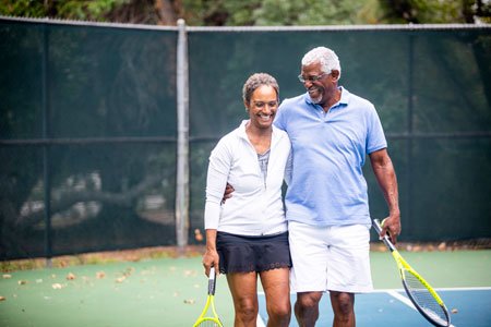 older couple playing tennis