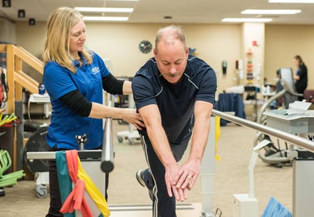 physical therapy  patient fred darga working with therapist kathy