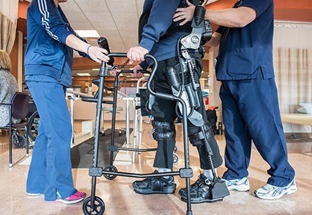 rehab patient jerome busam walking with exoskeleton