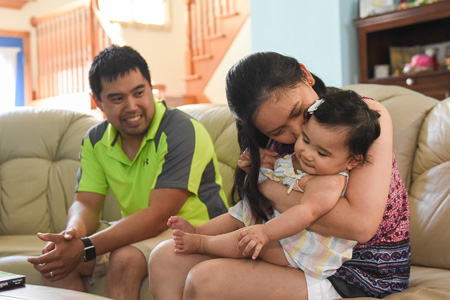 Infertility patient smiling at wife and daughter