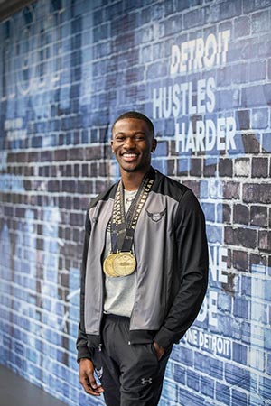 Randy Fry posing in front of mural story