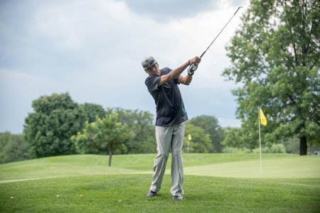 sports medicine patient rashad playing golf