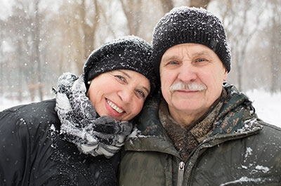 older couple standing in the snow