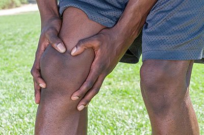 man holding his knee