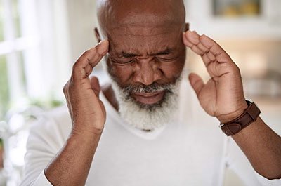 Man rubbing the sides of his head