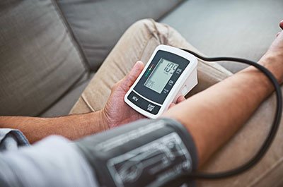 Man taking blood pressure at home