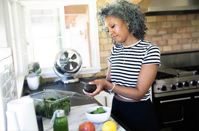 older woman making salad