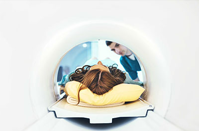 Woman in imaging machine laying on back