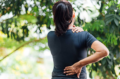 woman rubbing lower back