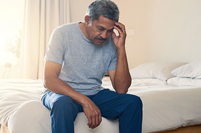 man sitting on bed