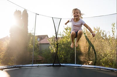 little girl jumping on trampoline