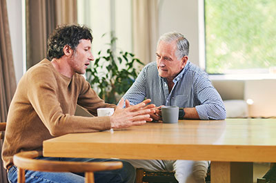 two men talking at table