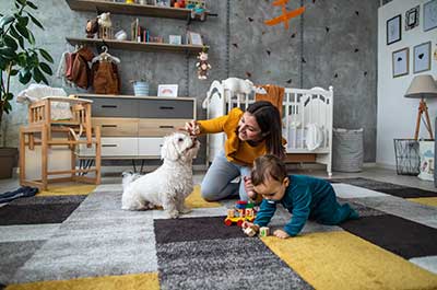 mom playing with baby and dog
