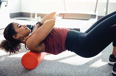 woman stretching with foam roller