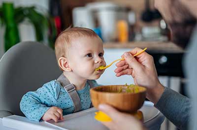 dad feeding baby