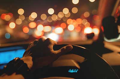 man driving at night