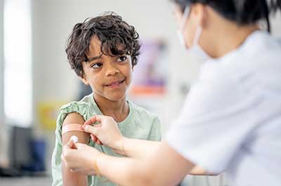 doctor giving child vaccine