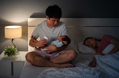 new dad feeding baby